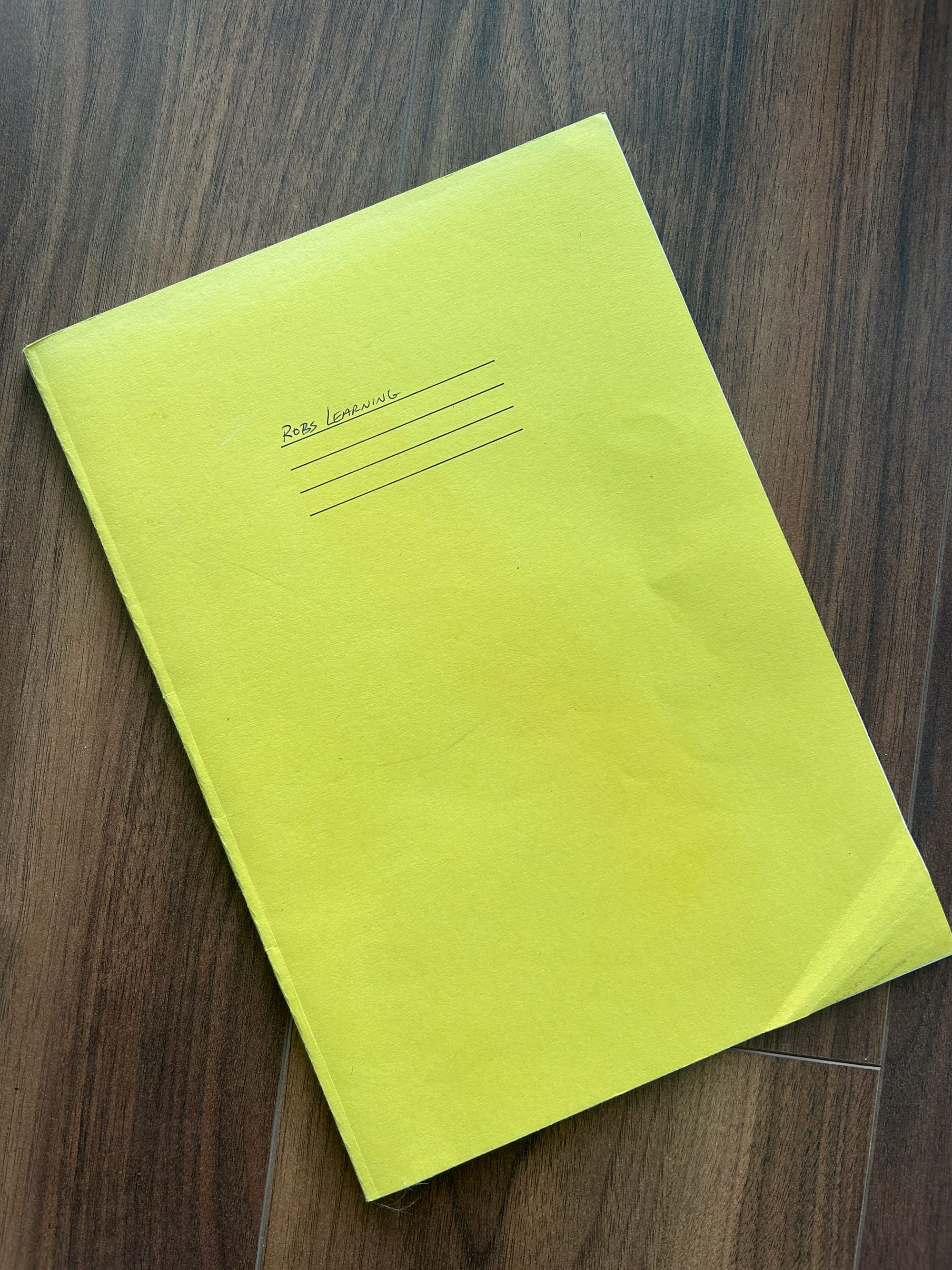 A photo of my kids old school exercise book, repurposed for dad's study notes.
