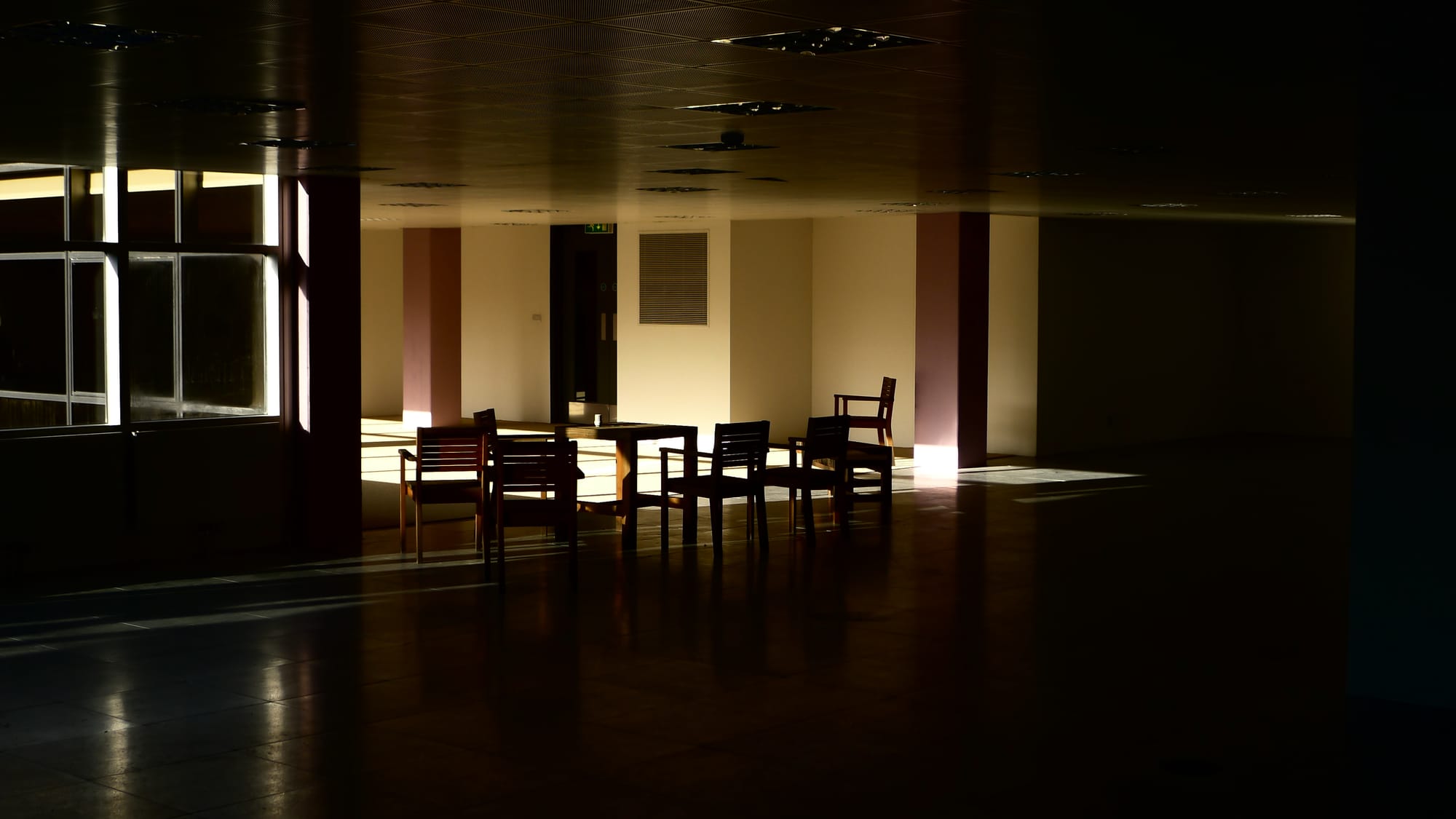 A photo of an abandoned office space with a few solitary chairs