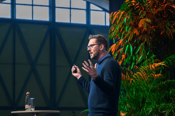 Rob Lambert on stage at a conference