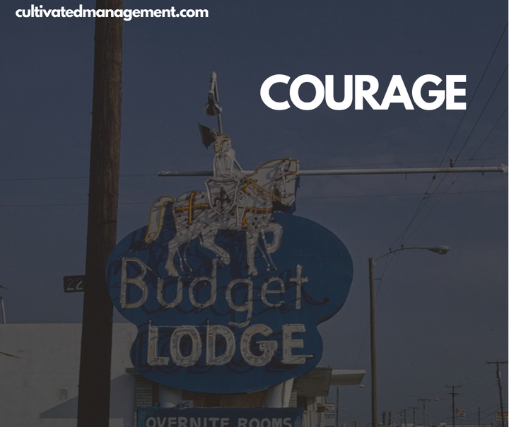 A photo of a motel with the knight on the roof with the word "courage" overlayed