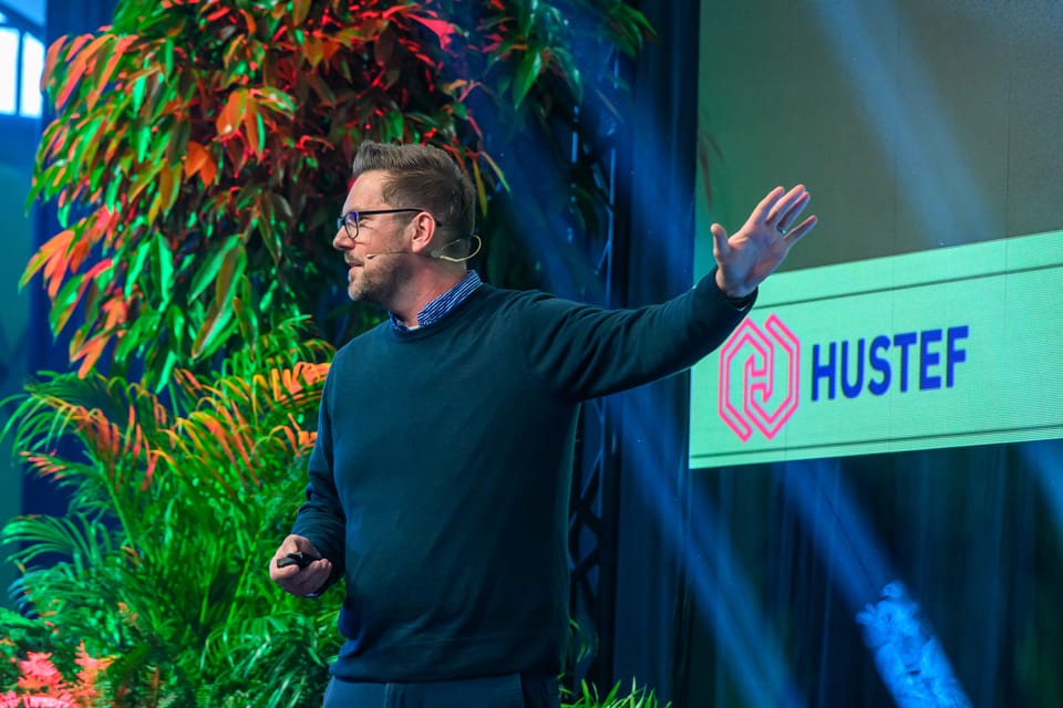 Rob Lambert speaking from the stage at a conference