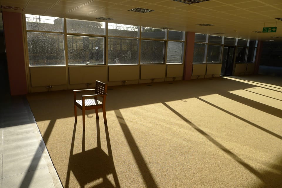 A photo of a chair in an abandoned building