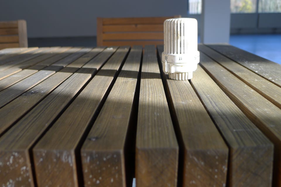 A photo of a radiator valve on a table